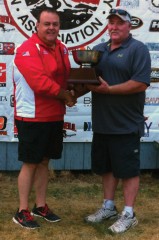 Ignacio's Kenny Canterbury, right, receives a sizable prize for his winning work at the NFAA Outdoor National Championships, held July 24-28 in Darrington, Wash.
