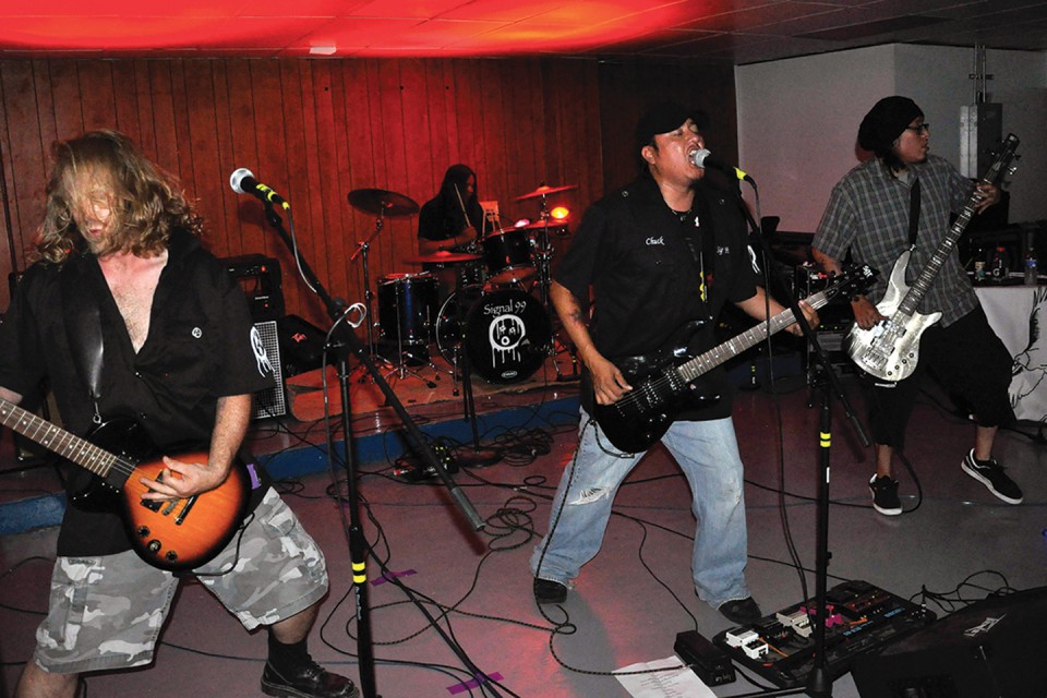 Chuck Haven (center), lead vocalist and guitarist of Signal 99