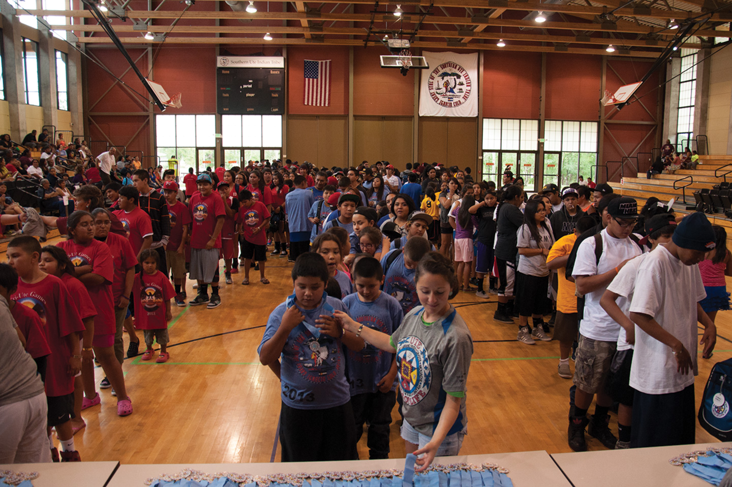 Participants from (left to right) the Northern Ute, Southern Ute and Ute Mountain Ute tribes line up inside the SunUte Community Center gym on Wednesday, July 24 to receive a medal and T-shirt.