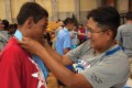 Thumbnail image of SunUte Community Center Director (right) Kristi Garnanez bestows a medal upon a Northern Ute participant.