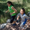 Thumbnail image of Arla Duran finished out the cross country run along the Bear Trail with one of the many participants.