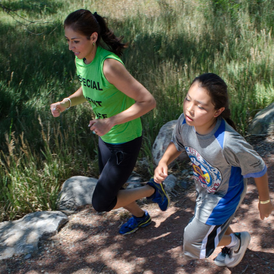 Arla Duran finished out the cross country run along the Bear Trail with one of the many participants.