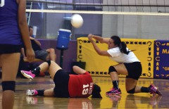 Ignacio JV libero Mariah Pardo (23, right) hits Don Cluff Court inside Kirtland (N.M.) Central's Bronco Arena to save a ball, while teammate Sarina Vigil (19) tries to avoid the ball's flight path. Ignacio swiped Game 2 of the Opening Night match by a score of 25-20, but lost Game 1 16-25 and Game 3 8-15 – leaving the varsity as the only red-and-white roster still with a chance at victory Aug. 29.