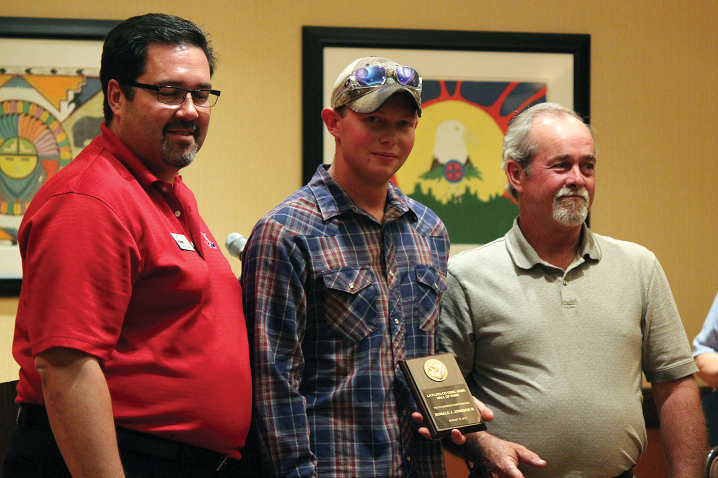 Ronald J. Johnson III accepts a plaque