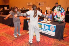 Robin Duffy-Wirth (seated), fitness manager at the SunUte Community Center, offered fun-sized chocolate bars to attendees of the Health Fair on Thursday, Nov. 7 at the Sky Ute Casino Resort’s Events Center – as long as they first did jumping jacks for four-and-a-half minutes to burn off the calorie equivalent. The Southern Ute Health Services Division hosted the fair.