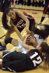 Ignacio's Ellie Seibel (35) and Cloe Seibel (12) team up to tie up possession against Farmington, N.M.’s Meeya Yazzie on Day 1 of Shiprock, N.M.’s Jerry Richardson Memorial/Lady Chieftain Invitational presented by Cellular One inside Shiprock’s Chieftain Pit.