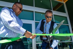 Chairman Clement J. Frost and Bruce Valdez, Growth Fund executive director, cut the ribbon opening the utilities building.