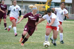 Now-graduated Ignacio senior Jasmine Red (6) clashes with Alamosa's Darby Bolt (14) during action at IHS Field during the 2014 season. Red was named Honorable Mention All-Southwestern League.