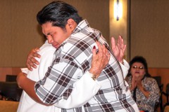 Tribal member Jack Frost III hugs Kathy Kent, of the Floyd family, after receiving the scholarship check that will go towards his college education Friday, May 15. 