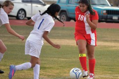 Ignacio's Sarina Vigil (18) surveys her options before clearing a ball away from Center's Faith Stults (left) and Shania Aguilar (1) during the teams' April 23rd match out in the San Luis Valley.