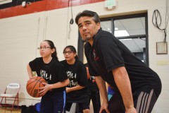 Shane Seibel coaches Darlyn Mendoza during a dribble exercise.