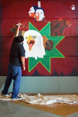 Tribal member artist, Conrad Thompson finishes up his cultural mural inside the SunUte Community Center, Wednesday, Jan. 20. All copyrights to the mural belong to Thompson and permission was given to the Drum to feature this photo. 