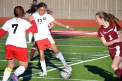 Ignacio's Namichen Oberly (13) sees her chance to advance the ball nearer teammate Tori Archuleta (7) during season-opening action versus Telluride, March 10 at IHS Field.