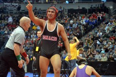 Ignacio’s Lorenzo Pena salutes the Bobcat fans inside Pepsi Center while the referee makes sure Wray’s Carlos Tarin (seated, right) is o.k. to stand after being forcefully pinned by IHS’ junior 160-pounder on Day 3 (Feb. 20) of the CHSAA Class 2A State Championships in Denver.