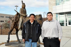 Sculpturist and artist, Oreland Joe (left) and Southern Ute Growth Fund Art Committee member stand before the statue created by Joe, which now presides in front of the new Growth Fund administration building.