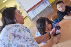 ShawMarie Tso shows Academy students how much sugar a single bottle of soda contains.