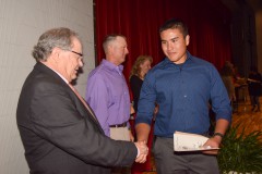 Natoni Cundiff, sophomore, shakes hands with Rocco Fuschetto as he accepts his award for academics.