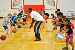 Joe Odhiambo, middle, shows the children a ball handling drill during the “Focused” basketball camp held at the Ignacio High School Friday, June 24. 