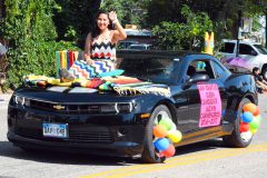 Jazmin Carmenoros, San Ignatius Queen Candidate smiles and waves at the crowd at the San Ignacio Fiesta Parade on Saturday, July 30.