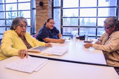 Tribal elder Pearl Casias (left) helps Lark GoodTracks and Cynthia Buckskin backtrack on their family’s history. 
