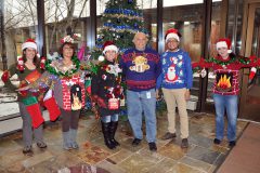 Ugly sweater contestants pose for a photo. 
