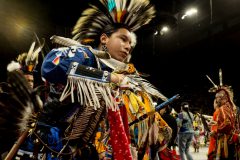 A young dancer moves to the sound of the drums, dance categories are broken up by age and style. 