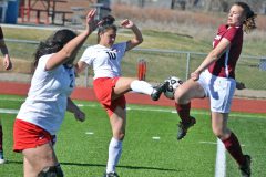 Ignacio’s Andrea Loya (10) successfully directs the ball away from Telluride’s Claire Shaver during the Lady Bobcats’ March 24 home opener at IHS Field.
