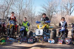 The young motocross riders with their bikes and awards, (left to right) Zackariah Loudenburg, Stephen Romero, Nakai Box, and Shyla Cloud.  
