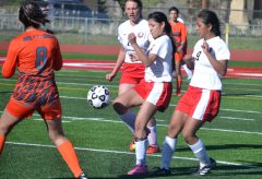 Ignacio’s Leela Rosa concentrates on settling the ball – rather than the whereabouts of Del Norte’s Krista Trujillo (8) – with her knee during April 21 action at IHS Field.