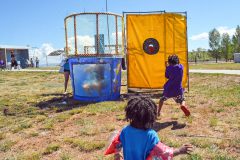 Keyon Alston runs for cover as he hits the red target and dunks Avionne Gomez in the dunk tank, one of the many events held at this year’s SUIMA field day.