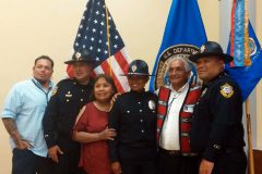 Ciara Baker smiles in celebration of her achievements and is surrounded by supporters after completing the rigorous police training in Artesia, N.M. (Pictured Left to Right) Representing the Southern Ute Council, Councilman Tyson Thompson, Chief Coriz Jr., Ida Baker (mother), Ciara Baker, John Baker Jr. (father) and field training officer Ferlando Fonseca.
