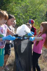 Kids from Hope Community Christian Academy clean up trash along the Bear Trail.