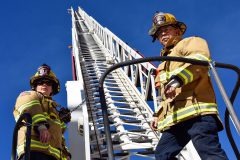 Los Pinos Firefighters, Heather Chesser and Kevin Griego work together to test hoses and perform ladder-training exercises on Monday, Oct. 23 aboard Ladder Truck 81.