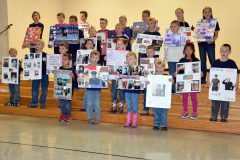 Hope Community Christian Academy (HCCA) students perform “Thank You” song for those in attendance, the students held poster boards adorned with praise and photos of Veteran family members.