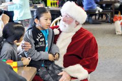 Aeden Richards looks at his Cousin Joseph Howell as he lets Santa know what he would like for Christmas. All of the children received a candy cane and were wished a Merry Christmas by Santa himself.