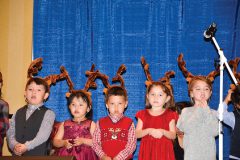 Southern Ute Indian Montessori Academy primary students perform their Christmas songs in front of family and friends during the Southern Ute Christmas Dinner and Program held at the Sky Ute Events Center Saturday, Dec. 16.