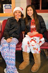 Angela Baker and Vanessa Gonzales lounge comfortably in pajamas at the Durango & Silverton Narrow Gauge Railroad Station Museum, Durango, Colo.
