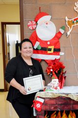 Laura Sanchez receives a certificate of achievement Saturday, Nov. 11, for fulfilling the certification requirements as defined by the National Native American Human Resources Association as a certified Tribal Human Resources Professional (THRP).