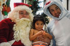 Atticus Harlan smiles with Santa at the SunUte pool Wednesday, Dec. 6, during annual the Swimming with Santa event.