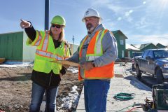 Mandy Brown, Project Administrator for the Southern Ute Tribal Housing Department (left), checks in with Bill MacGuffie, Southern Ute Water Plant Operator, during a tour of the Cedar Point Townhomes. 