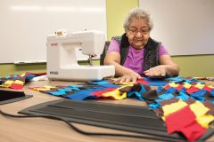 Southern Ute elder Kathleen Hatch works meticulously on her quilting fabrics, bringing the colorful patterns to life, Tuesday, Feb. 14. She said she never made a quilt before now and welcomed the opportunity for the new experience - even bringing her materials home to work on the project between classes at the Southern Ute Multi-Purpose Facility. 