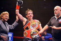 Flanked by WIBF President Barbara Buttrick (left) and referee Stephen Blea, Las Vegas, Nevada’s Layla McCarter takes in applause after defeating Albuquerque, New Mexico’s Victoria Cisneros inside the Sky Ute Casino Resort Events Center--with some serious fashion accessories at stake.