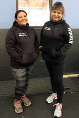AFTER: Tribal members, Brandi Raines (left) and Mikki Naranjo (right) smile as they strike a pose in their new sweaters.