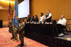 The Southern Ute Tribal Council looks out behind Bruce LeClaire and Rudley Weaver as they carry the flags into the General Meeting on Thursday, April 12 at the Sky Ute Casino & Resort. 