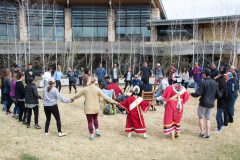 Ignacio’s Yellow Jacket drum group sings, as Golden High School and Southern Ute Head Start students join hands together during a round dance song, outside the Southern Ute Museum Monday, April 16. 