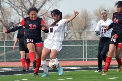 Ignacio’s Chloe Velasquez (15) tries blasting the ball through Alamosa’s Jaqueline Palacios (16) and to safety during the Lady Bobcats’ April 19 trip to AHS.