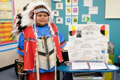 Ignacio Elementary School fourth grader, Kylan Velasco, dressed as Buckskin Charlie, stands next to his presentation. Students gave information regarding their boards when people approached their station