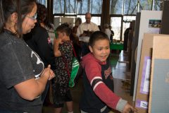 Lower elementary student, Sinaav Larry points to a project for Kinder guide, Cheryl Ongtowasruk to see at the Southern Ute Indian Academy’s Knowledge Night on Thursday, April 26. 

