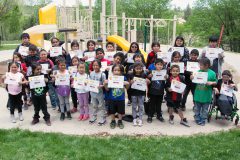 SUIMA students stand together after they are awarded for their successful completion and participation in the SPARK (Sports, Play and Active Recreation for Kids) afterschool program on Tuesday, May 22. 