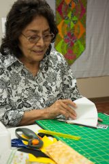 Southern Ute elder Ella-Louise Weaver lays out pieces of fabric to sew during a paper piecing quilting workshop held at the Southern Ute Multi-Purpose Facility on Wednesday, June 6.